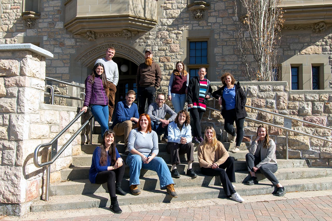 Endowed Chair research group sitting on University building steps